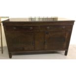 A vintage dark wood 2 door, 2 drawer sideboard with drop down handles.