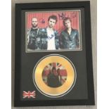 A photograph of the Band Muse with facsimile signatures and a gold presentation disc.