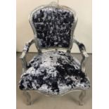 A decorative silver framed bedroom chair with blue/grey crushed velvet upholstery.