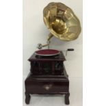 A wooden cased table top, wind up, trumpet gramophone marked "Victrola".
