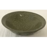 A Chinese porcelain celadon glazed shallow bowl with dragon design to inner bowl and pierced detail.