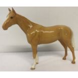 A Beswick Bois Roussell Racehorse figurine in Palomino colourway with circular back stamp.