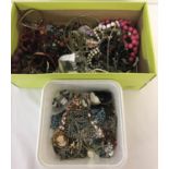 2 boxes of mixed vintage and modern costume jewellery to include brooches, necklaces and bracelets.