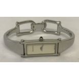 A ladies horse bit clasp Gucci watch with stainless steel bracelet and case.