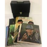 A vintage black record case containing 30 assorted Frank Sinatra vinyl records.