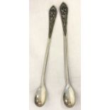 2 silver preserve spoons with beaded rim handles and floral decoration. Both Marked '800'.