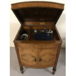 A vintage walnut cabinet gramophone by Mastertone.