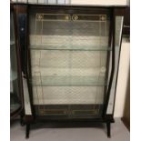 A mid-century display cabinet, mirror trim to front, with double doors and 2 shelves.