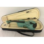A cased Junior 1/2 sized violin in turquoise colourway with sparkly finish.