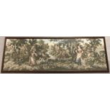 A large framed and glazed tapestry depicting an 18th century pastoral scene.
