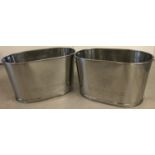 A pair of Bollinger Champagne buckets with engraved details to sides.