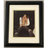 A framed and glazed signed colour photographic print of singer Elvis Presley complete with CAO.