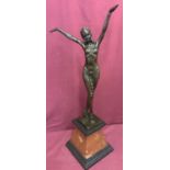 An Art Deco style bronze figurine of an Arabian style semi nude dancer, mounted on a marble base.