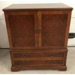 A vintage cherry coloured wooden 2 drawer, 2 door cabinet.