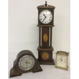 A miniature grandfather style clock with marquetry detail to case.