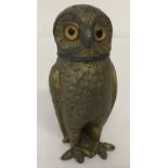 A vintage owl shaped metal pepperette with amber glass eyes.