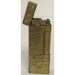 A vintage gold plated rollagas Dunhill lighter with crisscross design to body and lid.