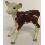 A ceramic Beswick figurine of a Hereford calf, Model #901b.