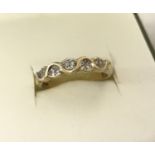 A 9ct gold twist design half eternity ring set with 10 small diamonds.