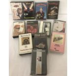 A collection of 12 vintage mixed genre music cassettes.