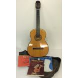 A vintage 6 string acoustic guitar by Angelica #2852 complete with fabric carrycase.
