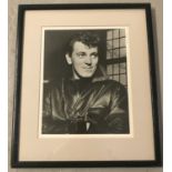 A framed and glazed signed black and white photograph of rock and roll star Gene Vincent.