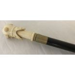 A bone topped walking cane with handle carved in the shape of a divers helmet.
