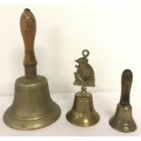 Three brass hand bells of varying sizes, 2 with wooden handles.