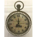 A brass cased pocket watch with beaded detail to surround front and back.