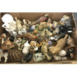 A large collection of ceramic and resin animal figures.