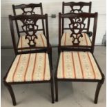 A set of 4 reproduction dining chairs. With decorative work to backs.