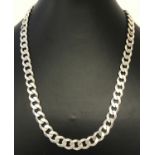 A heavy curb chain necklace approx. 18 inches long. Claps and fixing marked 925 with scales mark.