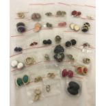A box of vintage clip on style earrings, comprising 32 pairs in varied colours and styles.