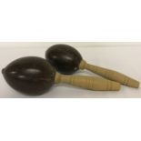 A pair of vintage wooden handled coconut maracas.