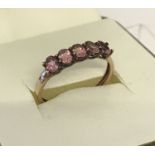 A 9ct gold ladies dress ring set with 5 oval cut pink stones.