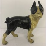 A vintage painted, heavy cast iron figurine of a French Bulldog.