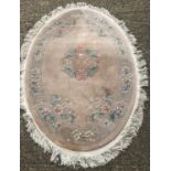 An oval Chinese wool rung with fringed ends.