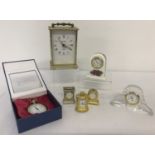 A collection of 5 miniature clocks in brass, ceramic and glass.