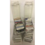 4 clear plastic vintage cases containing a total of 48 assorted cassette tapes.