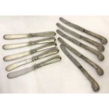 A set of 5 silver handled butter knives with classic scroll decoration to handles.