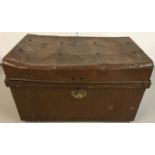 A vintage tin trunk with studs to lid and brass clasp.