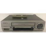 A vintage Daewoo Video+ VHS HQ video player with remote control.