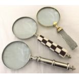 3 large magnifying glasses, one with a chunky faceted glass handle.