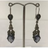 A pair of white metal vintage style drop earrings set with large blue stones and marcasite's.