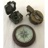 2 brass cased compasses together with a wooden dome topped desk compass.