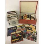 2 boxes of 1970's and 80's vinyl 7" singles.