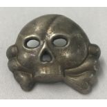 A WWII style Waffen SS Allgemeine Totenkopf cap skull badge.