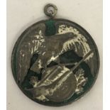 A German 1930 shooting medal. Green enamel base with eagle rifle and target decoration.