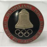 A German WWII style black & red enamelled 1936 Olympics pin back badge.