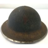 A British WWII MkII steel helmet with hand painted skull and crossbones decal.